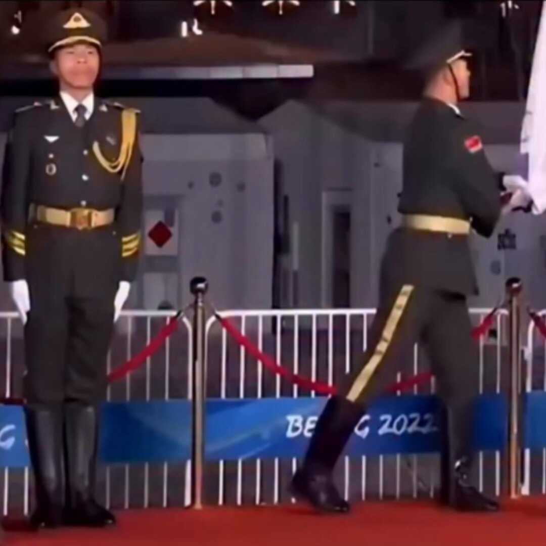 Beijing 2022 ceremony man trying not to laugh