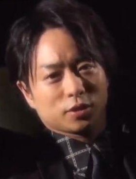 Man drinking from cup with Kazunari-san Shibuya text (photo 2 of 4)