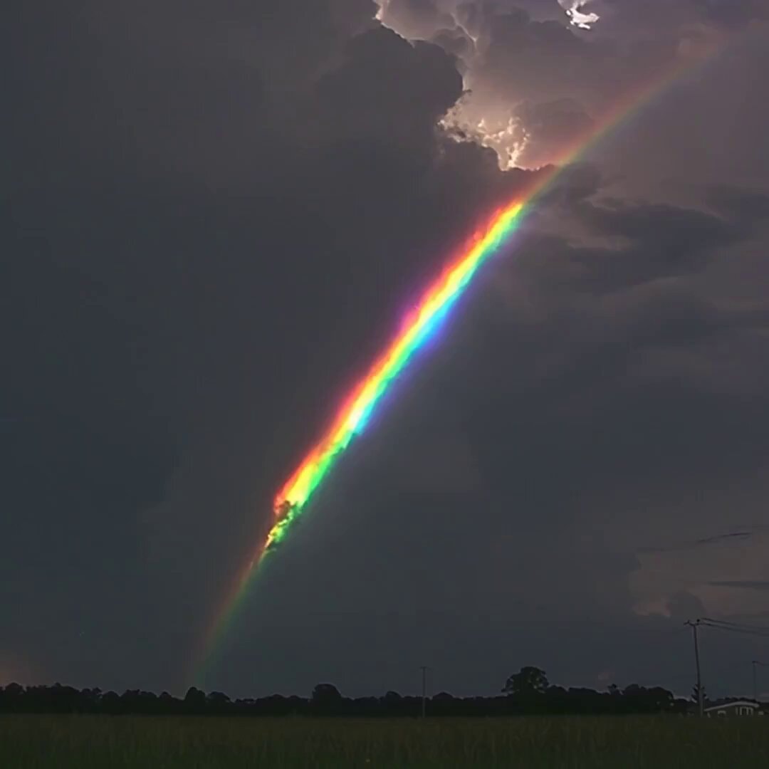 dramatic rainbow in storm clouds