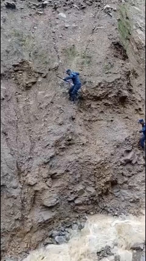 Nepal Police climbing mountainside