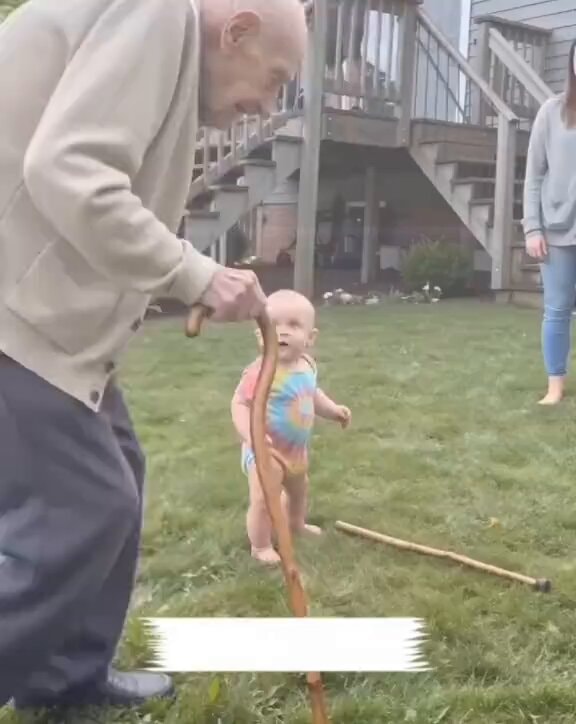 elderly man and baby moment