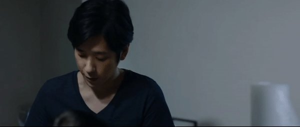 man in dark blue v-neck somber man in dark blue v-neck somber