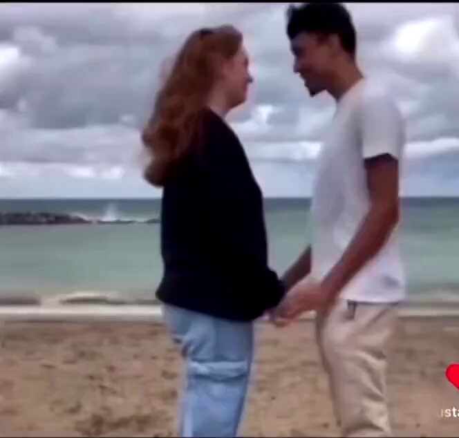 Couple on beach holding hands