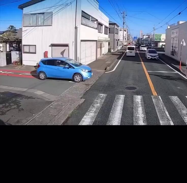 Kid on street in blue car