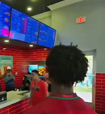 young person with dreadlocks in fast food