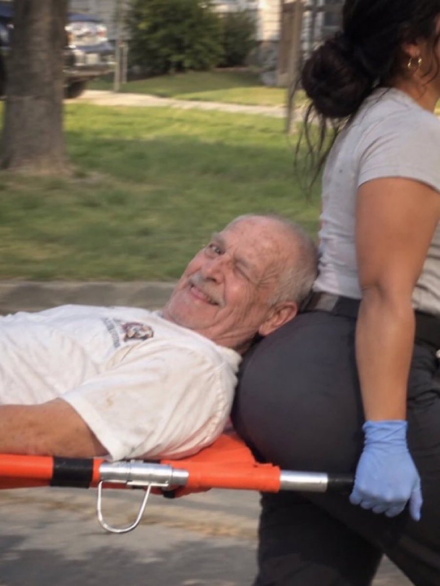 elderly man winking from stretcher elderly man winking from stretcher