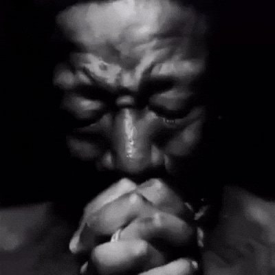 Somber hands clasped black and white GIF
