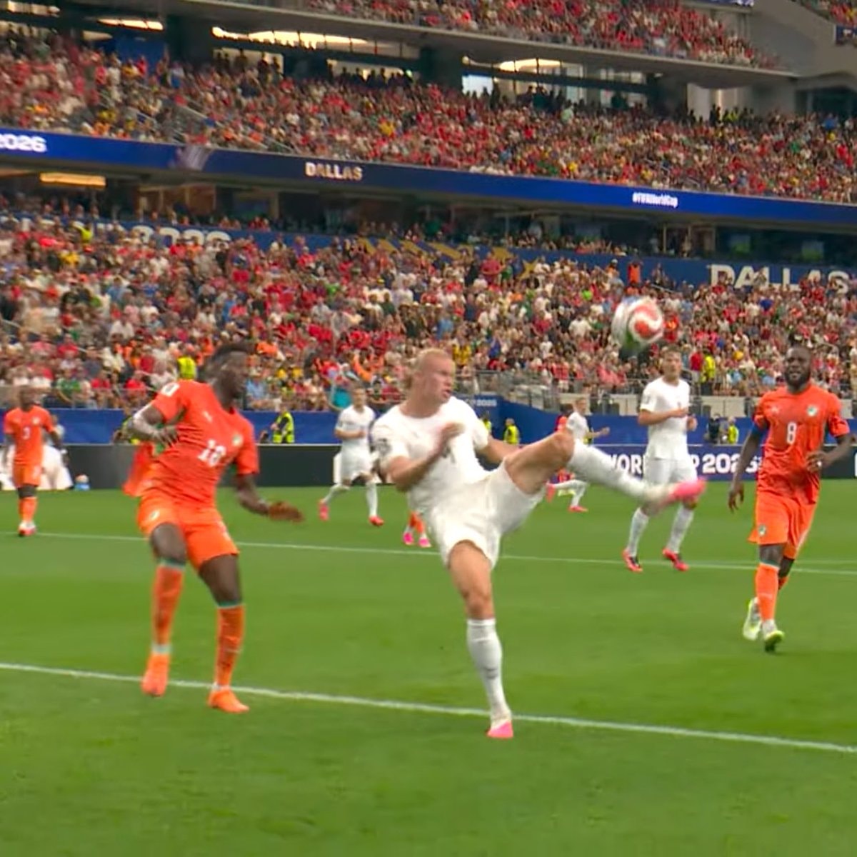 Player in orange jersey leaps for header (photo 2 of 2)