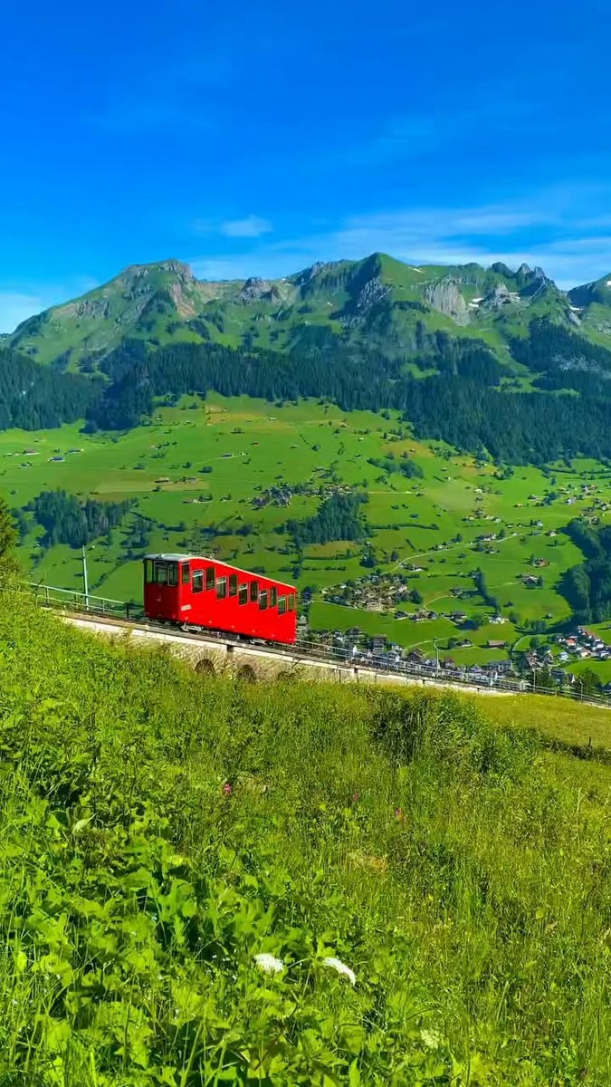 Red cogwheel train mountain climb