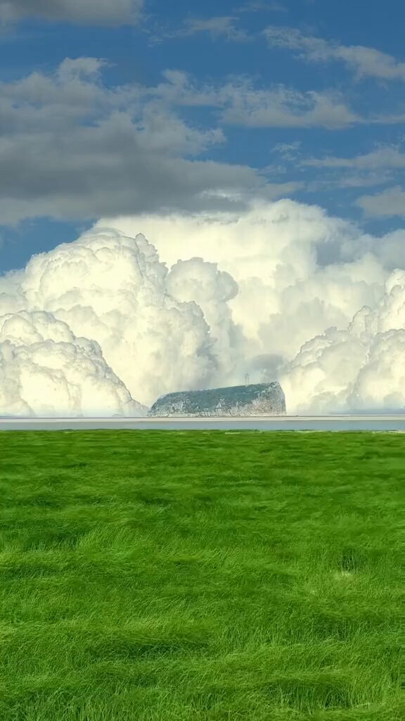 Lighthouse island under massive clouds