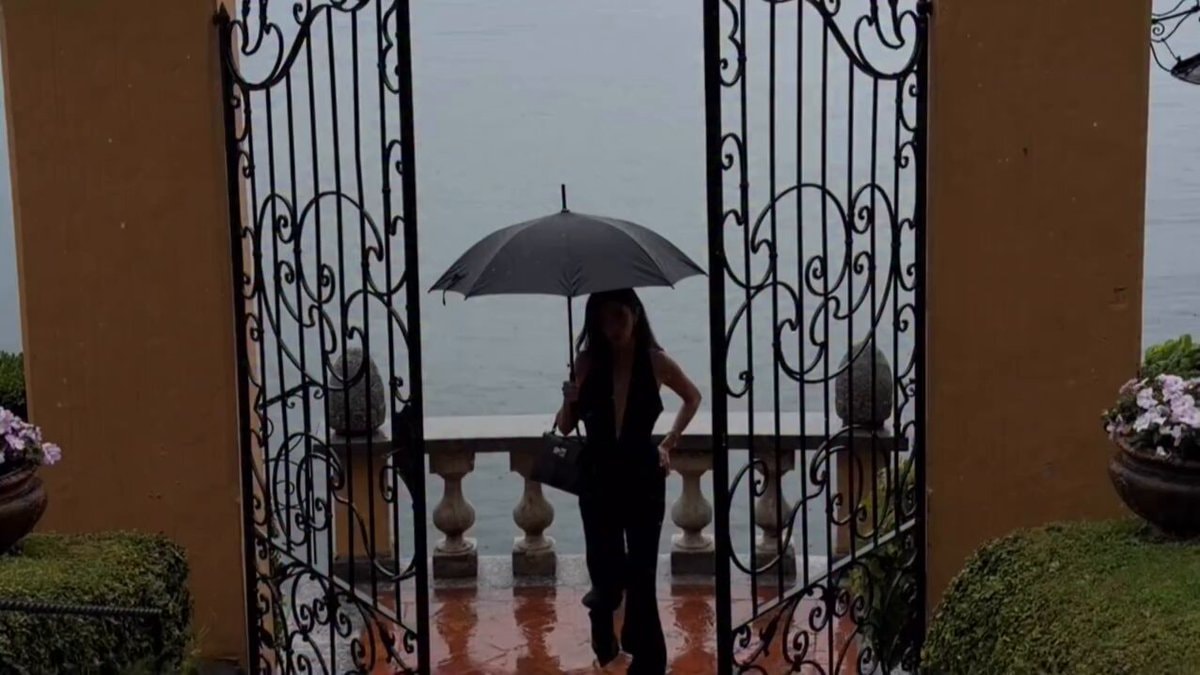 woman in black jumpsuit with umbrella