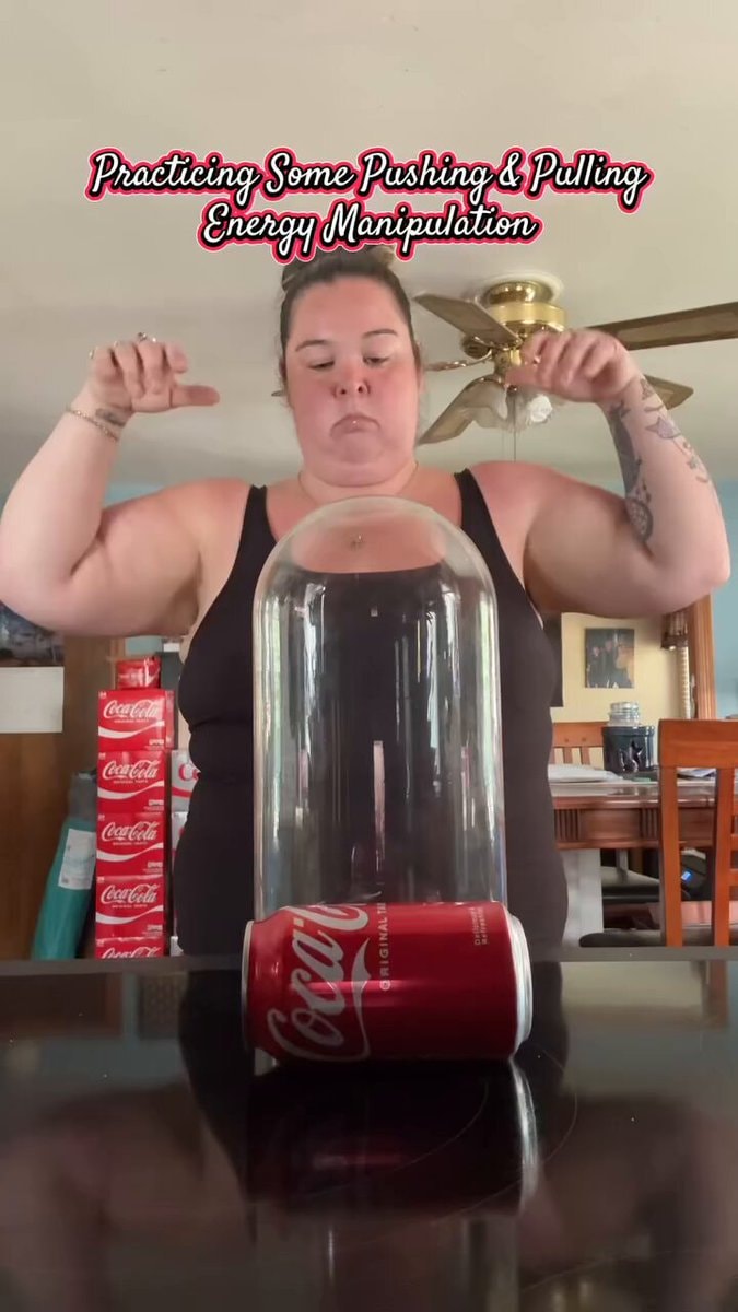 Woman practicing telekinesis on Coca-Cola can