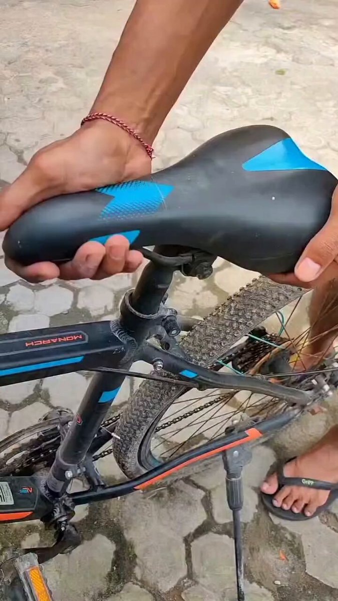 hands adjusting a bike seat