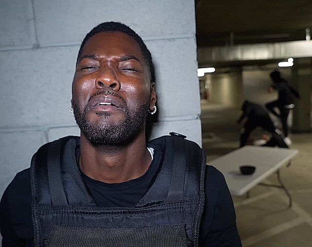 man in bulletproof vest garage chaos