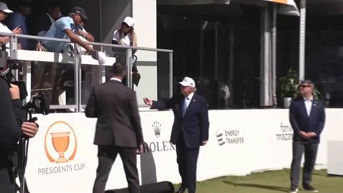 Trump signs hats at Presidents Cup
