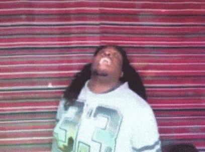 Rihanna laughing in graphic tee