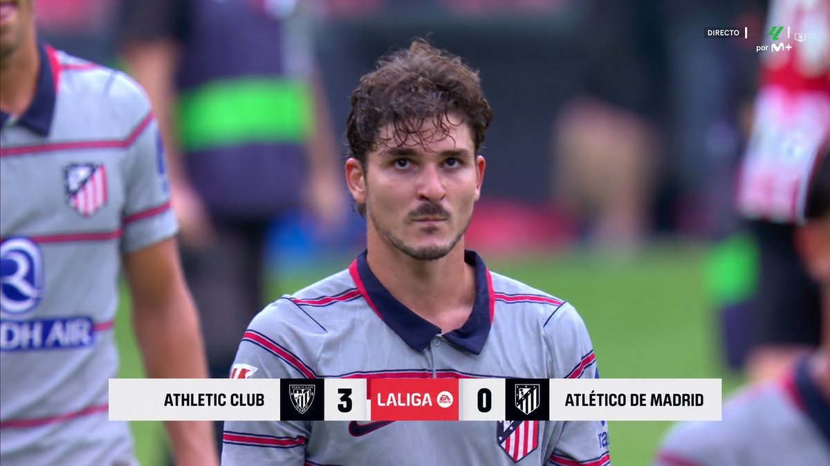 soccer player in grey and red jersey