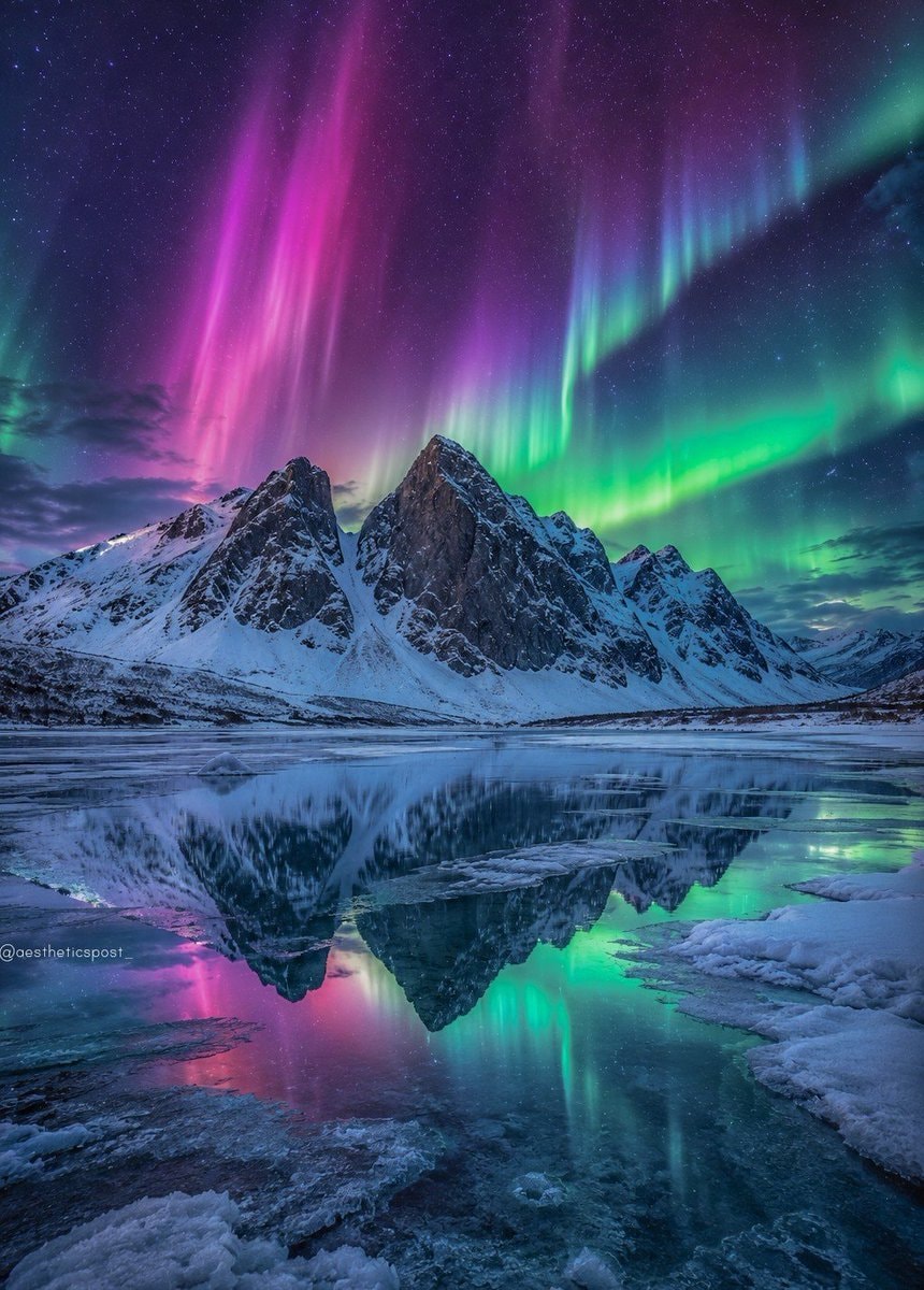 aurora borealis over snow-capped mountains