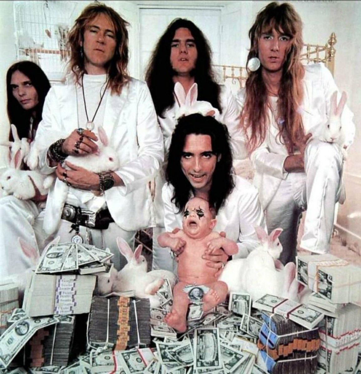 Men in white suits with rabbits and crying baby
