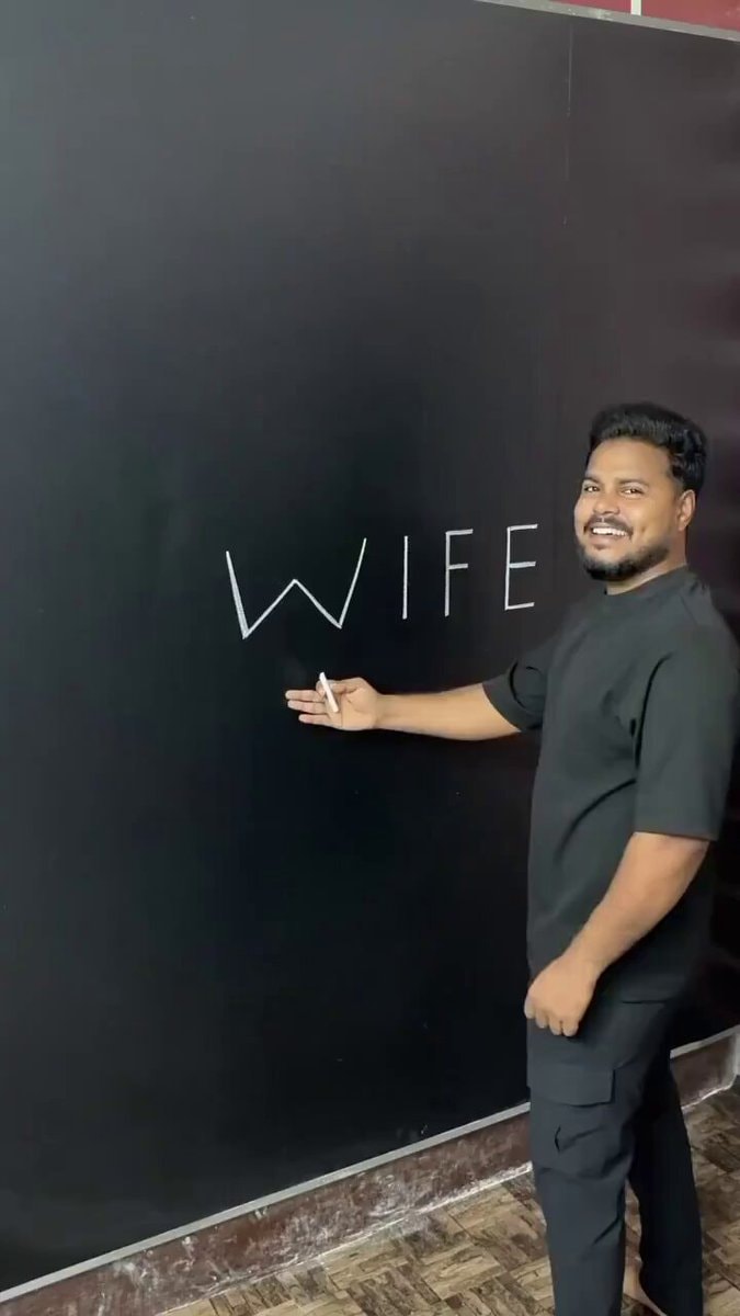 Man writes WIFE on wall with chalk