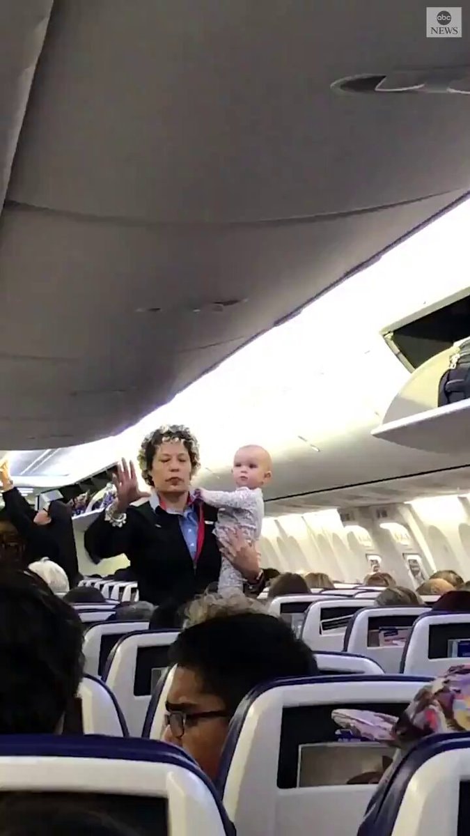 Southwest flight attendant holds baby