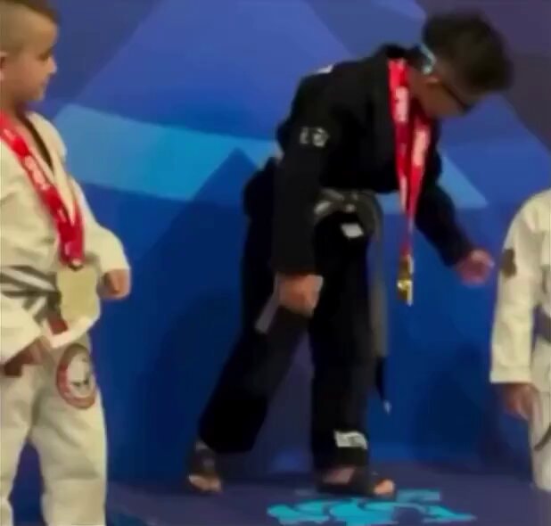 Young martial artists medal podium moment