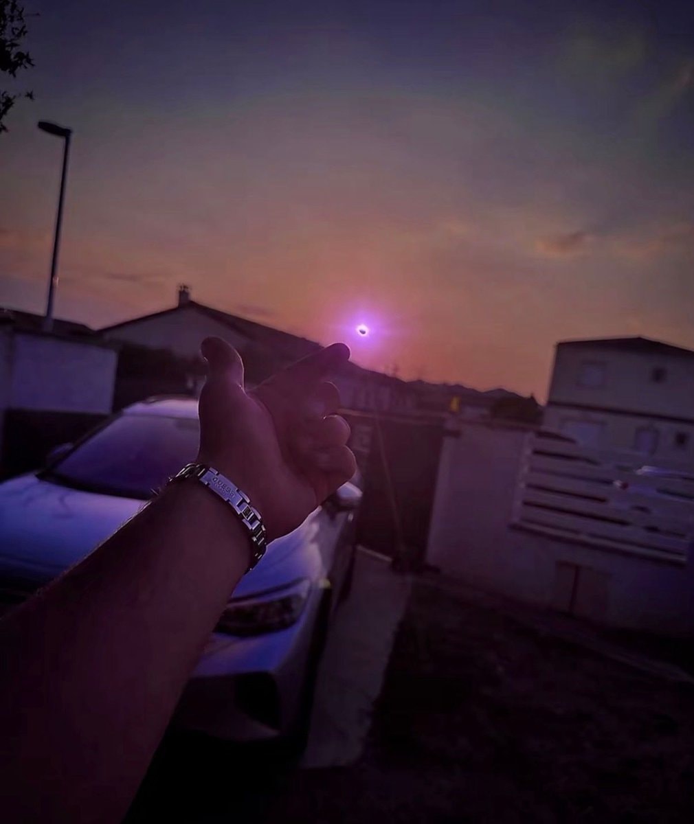 hand reaching to eclipsed sun