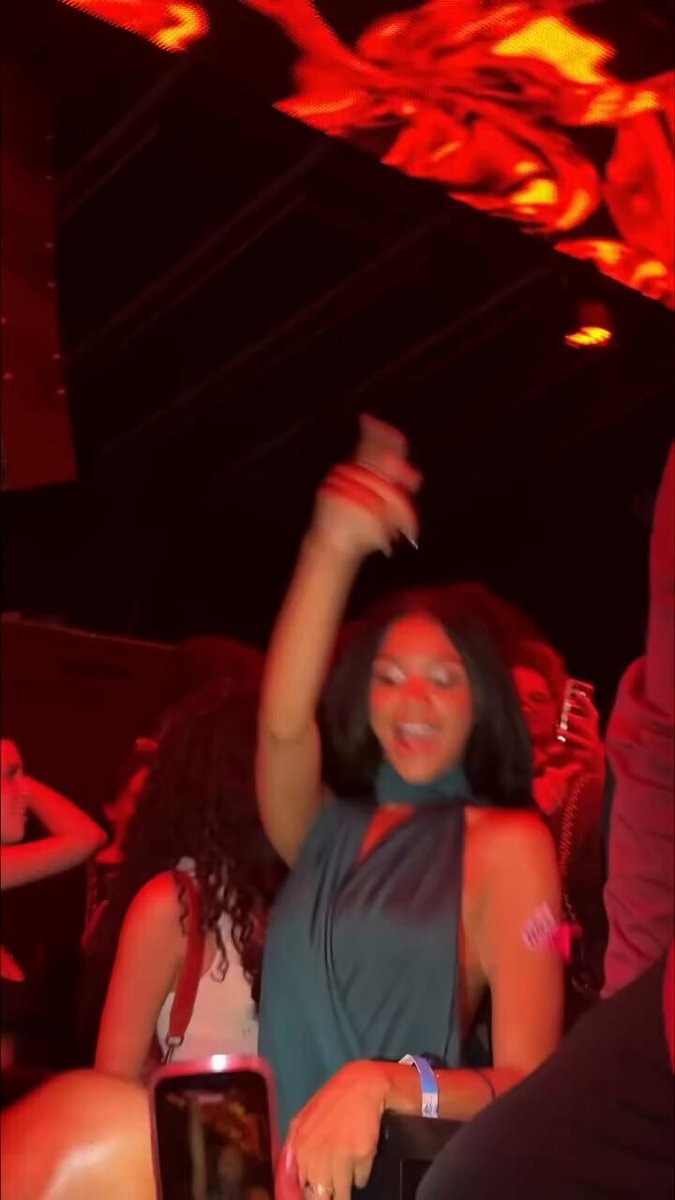 young woman dancing teal dress