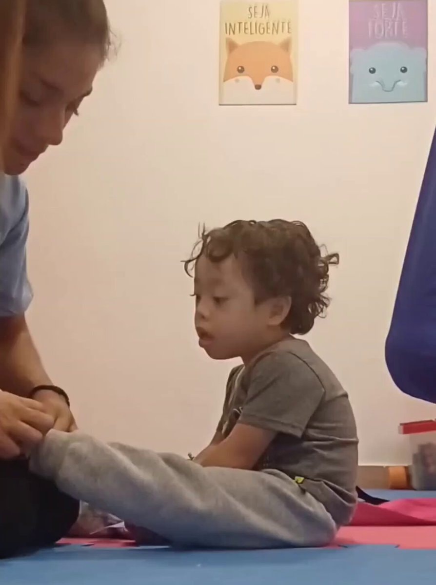 Boy with Down syndrome kisses therapist