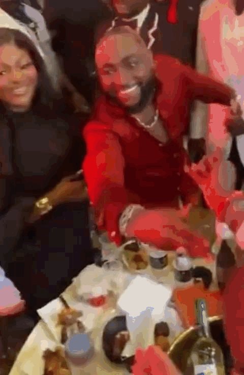 man in red suit reacts to Spurs fans