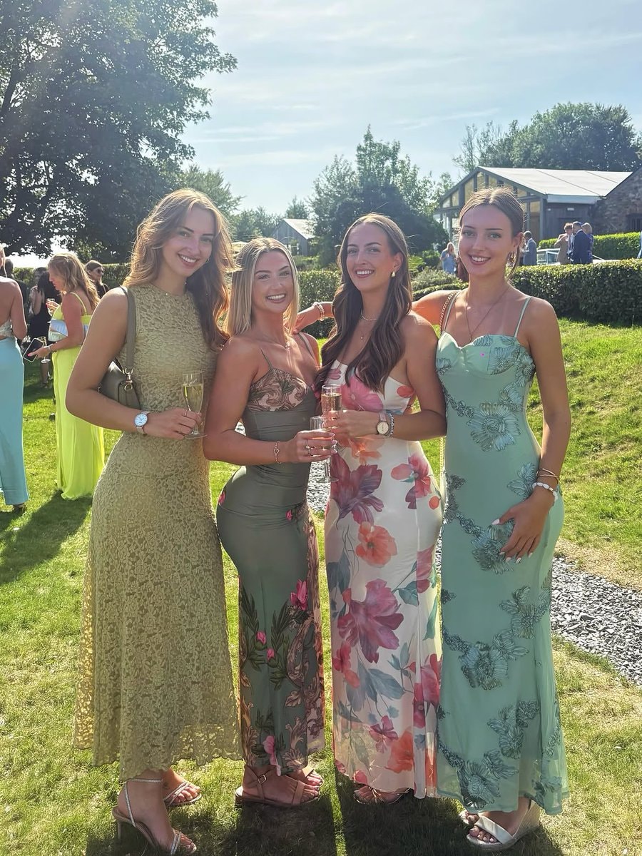 four women in elegant dresses