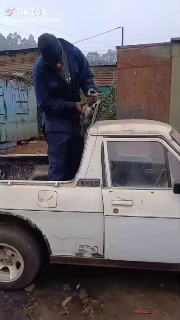 Man grinding truck roof