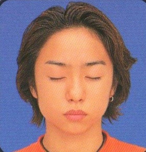 Young Asian person in orange shirt (photo 2 of 4)