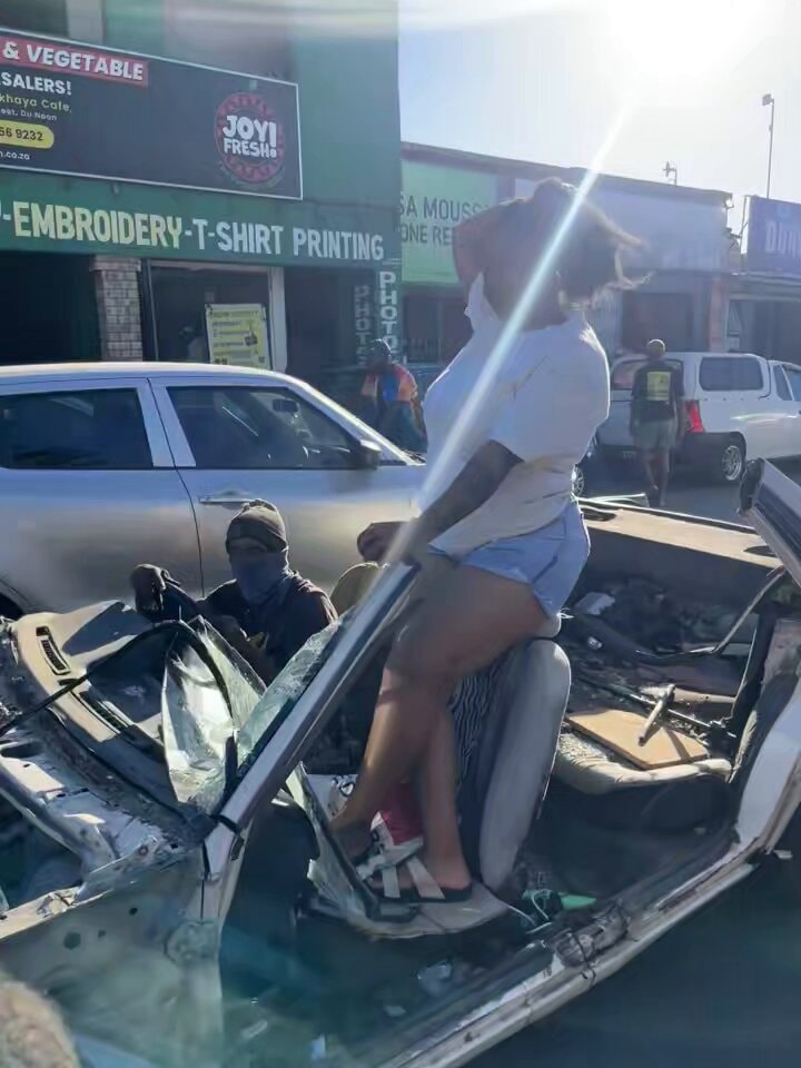woman in damaged car