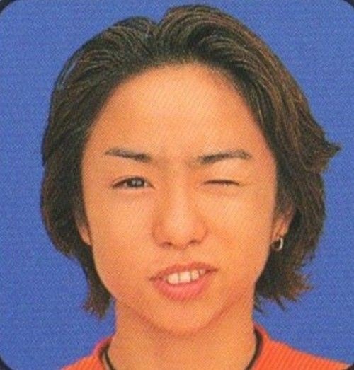 Young Asian person in orange shirt (photo 3 of 4)