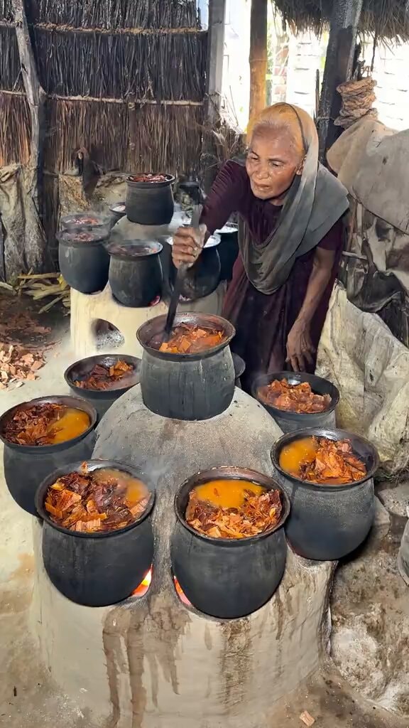 Elderly woman stirring traditional outdoor cooking Elderly woman stirring traditional outdoor cooking