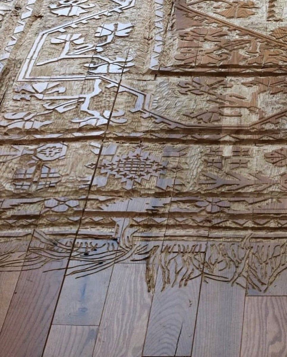 intricately carved rug (photo 2 of 3)