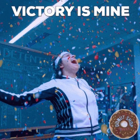 person celebrating with arms outstretched GIF