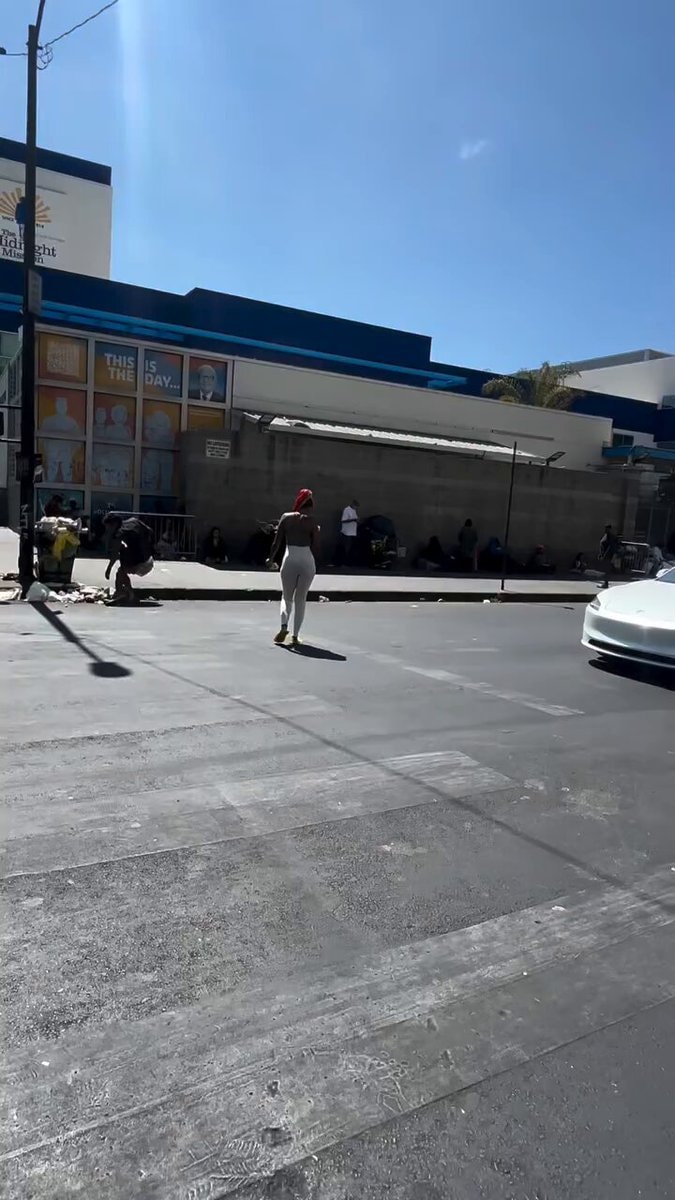 woman distributing cash to homeless