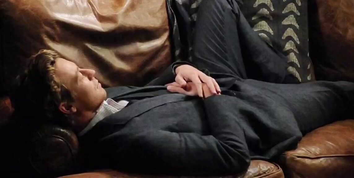 Man resting on leather couch