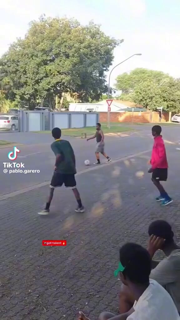 kids playing soccer in the street