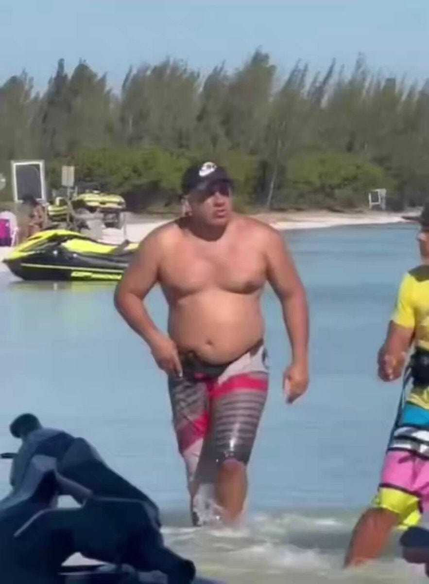 Man in swim trunks at the lake