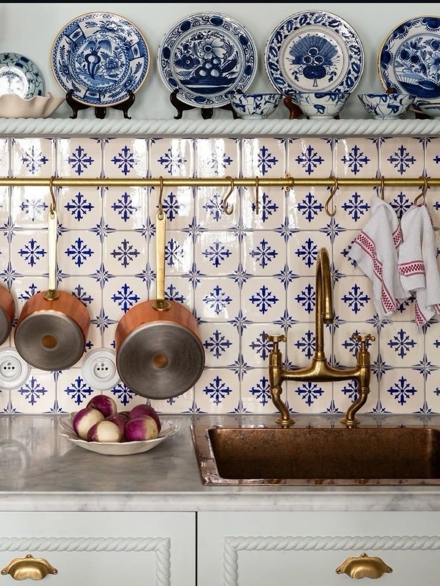 Gold faucet on colorful tiled wall (photo 2 of 4)