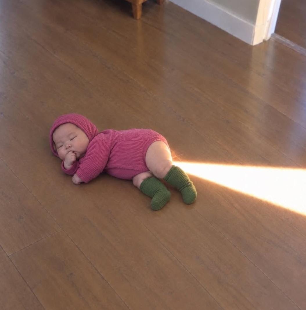 baby on wooden floor