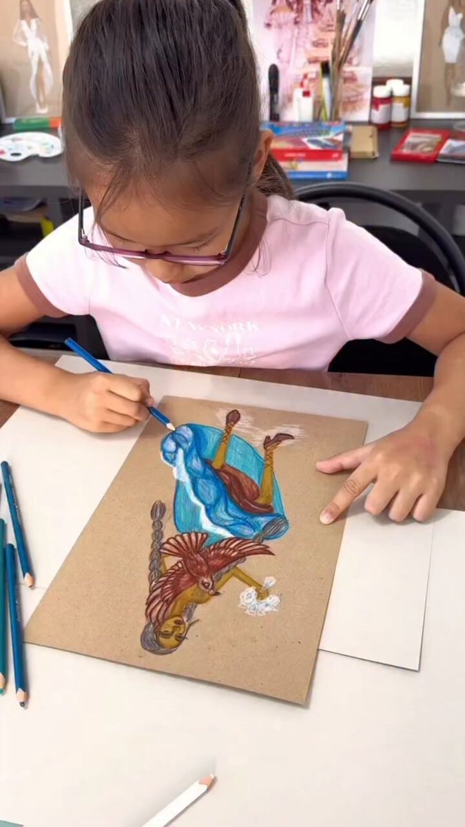 Young artist draws high-fashion woman with bird