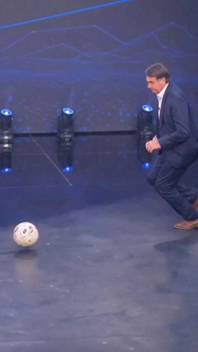 Man in Suit Playing Soccer