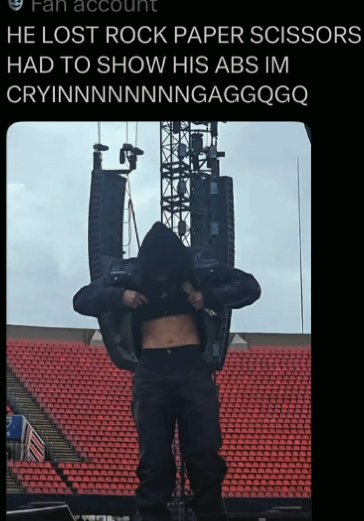 person lifting shirt on stage