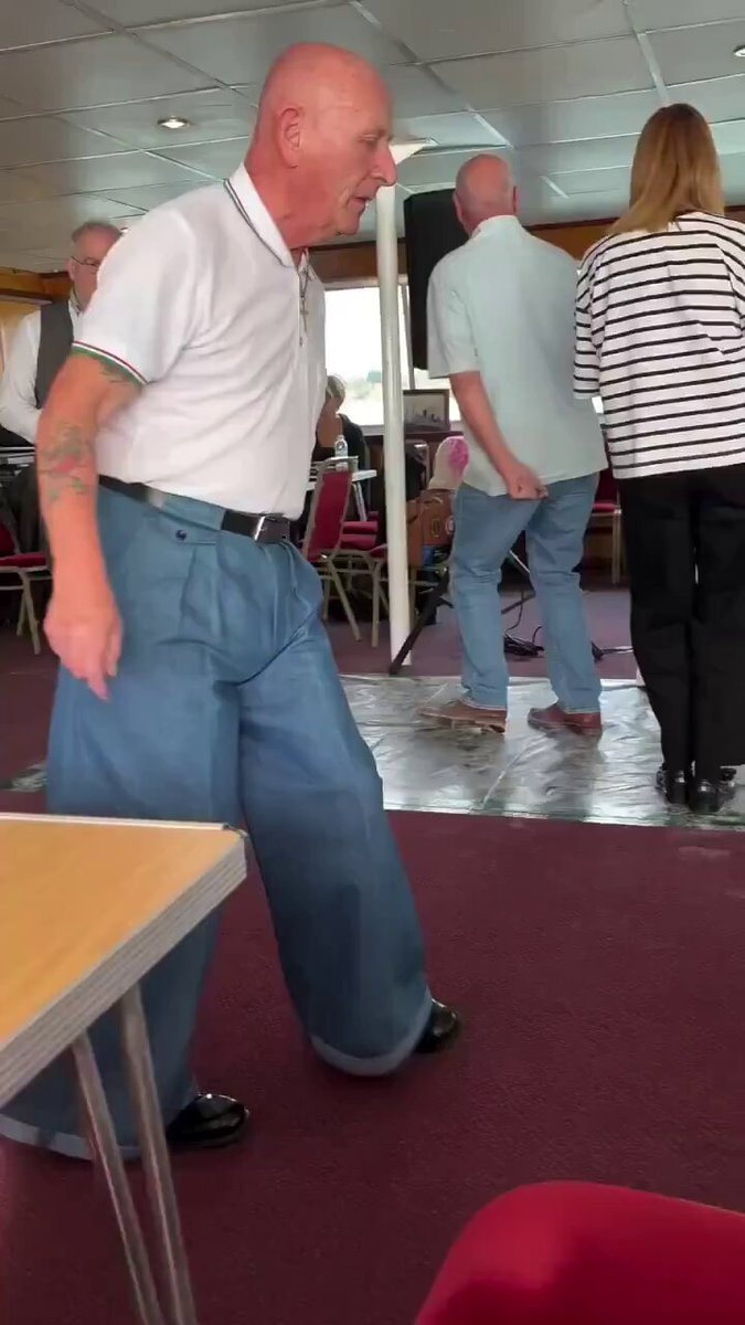 Bald man dancing at boat party