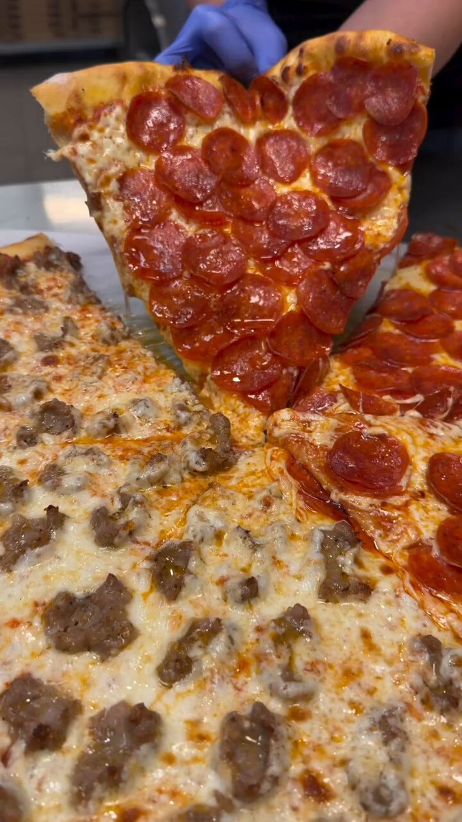 Pizza slice being lifted