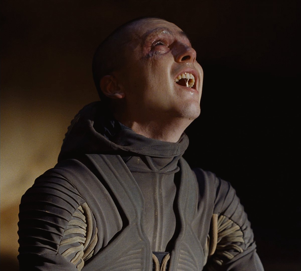 man with shaved head and injuries reaction